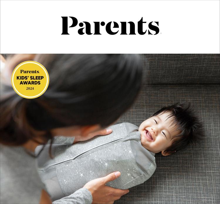 A magazine image of a baby smiling at the woman holding her