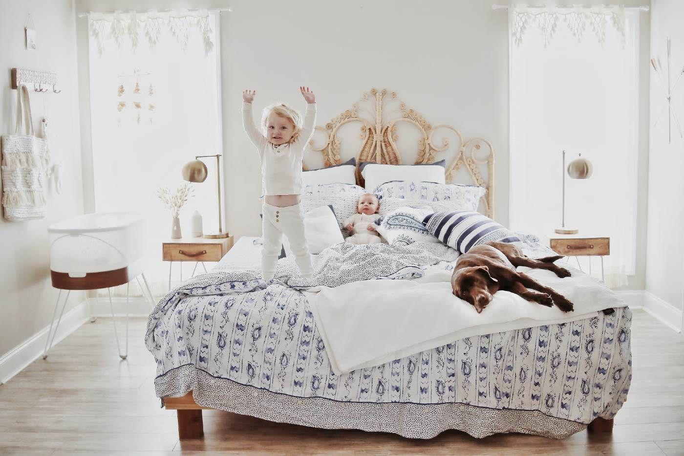 Pet benefits for kids - young kids playing on bed with dog