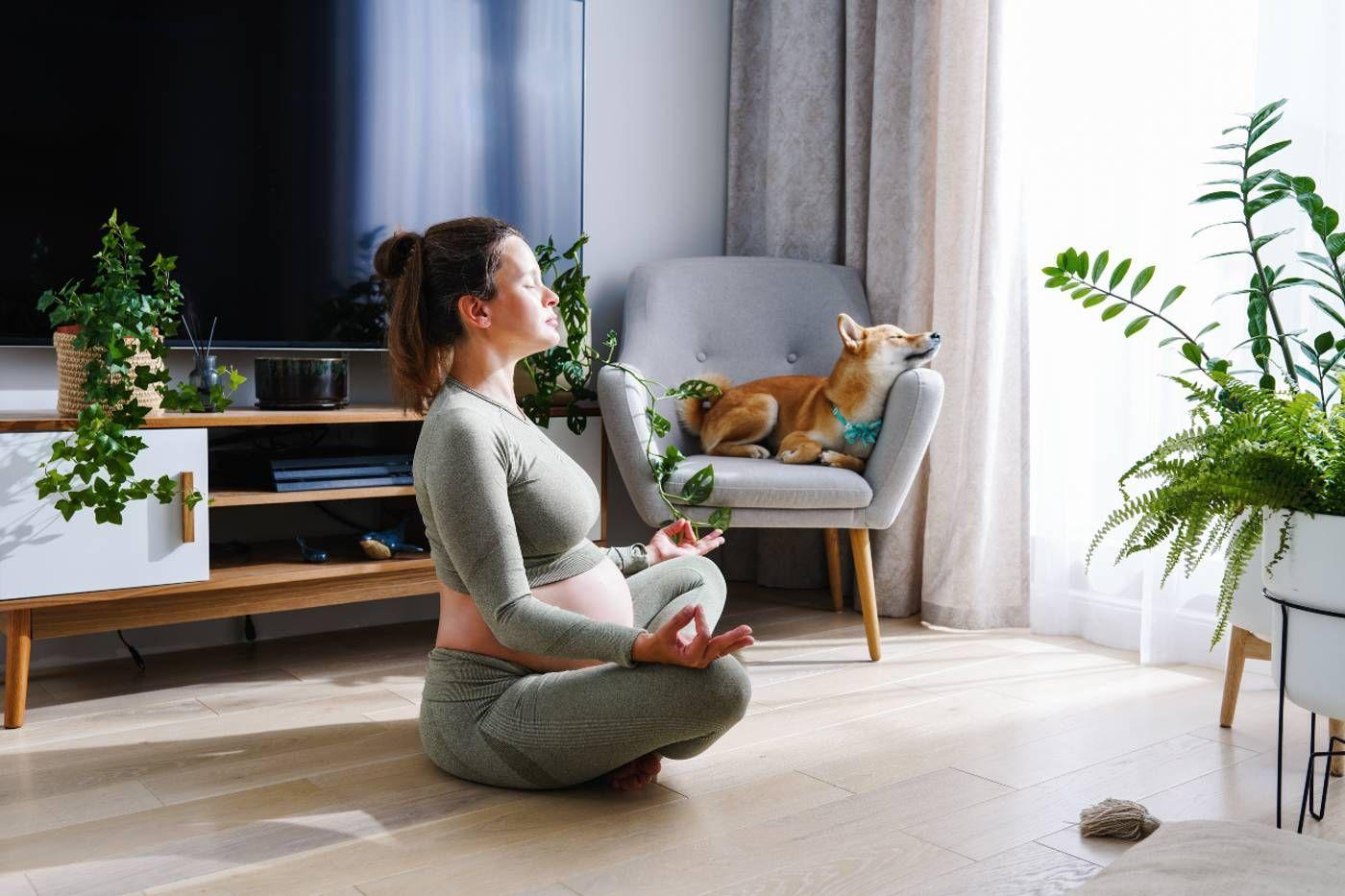 pregnant woman meditating on floor