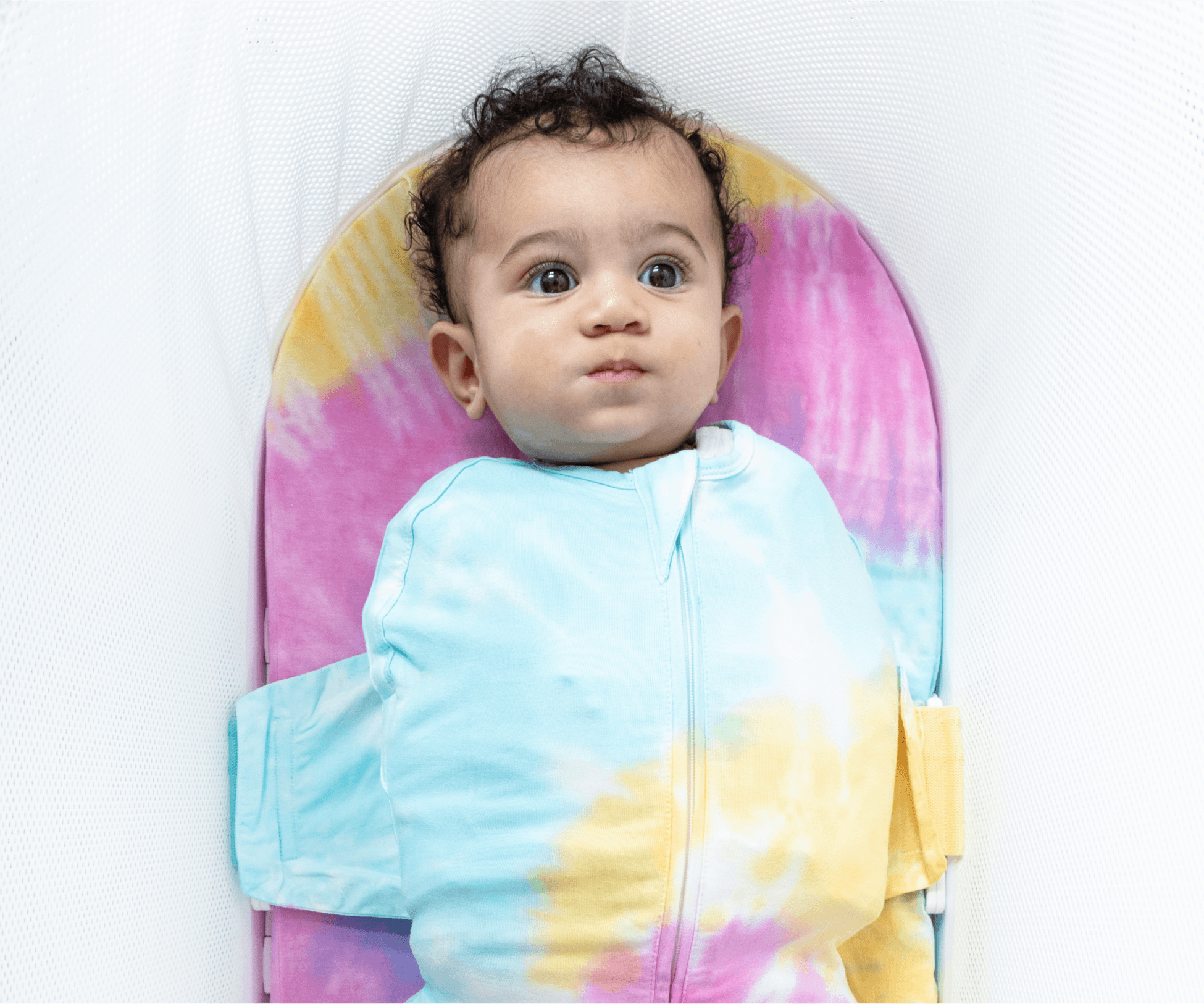 A baby in the SNOO Sleep Sack inside the SNOO bassinet