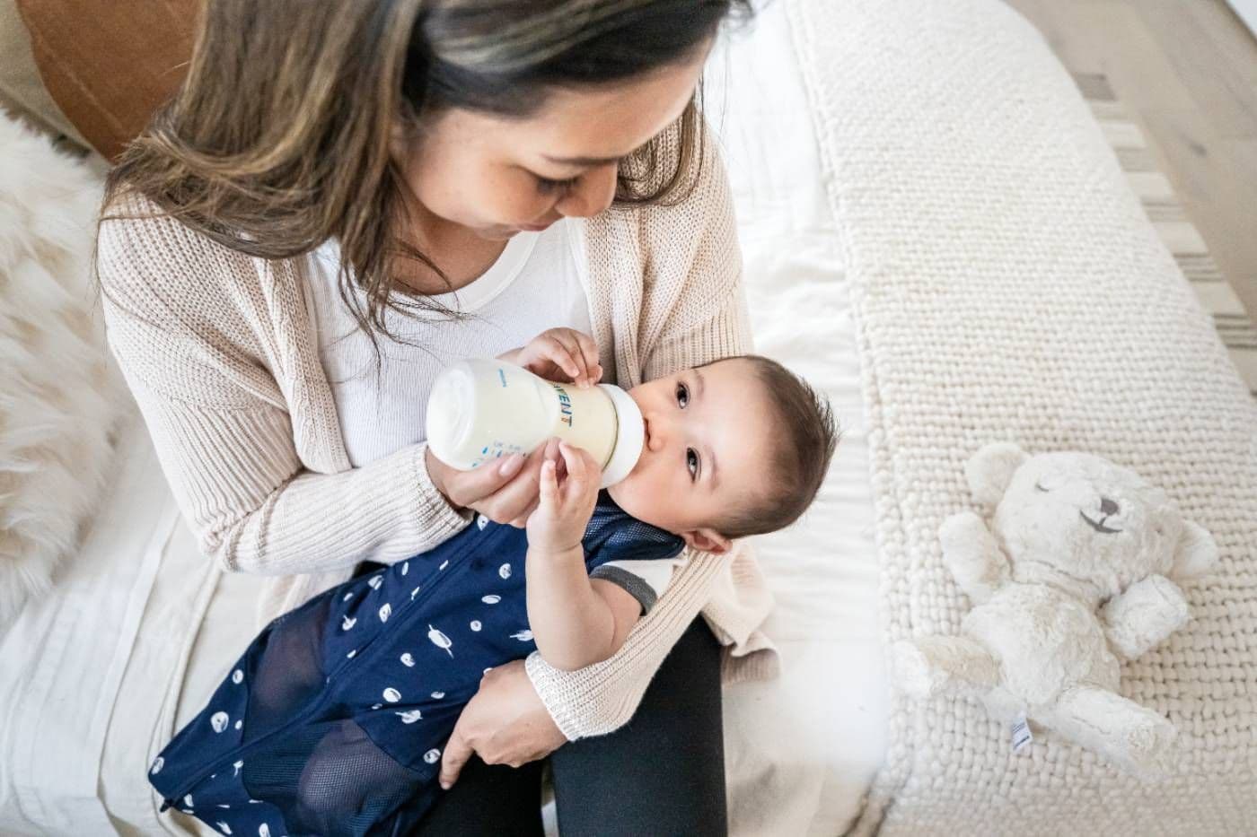 Baby drinking supplemented formula from bottle