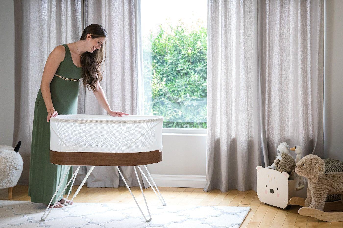 A mum looks into her SNOO smart sleeper