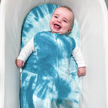 Baby happy in SNOO in Blue Tie-Dye SNOO Sack on Blue Tie-Dye SNOO Sheet